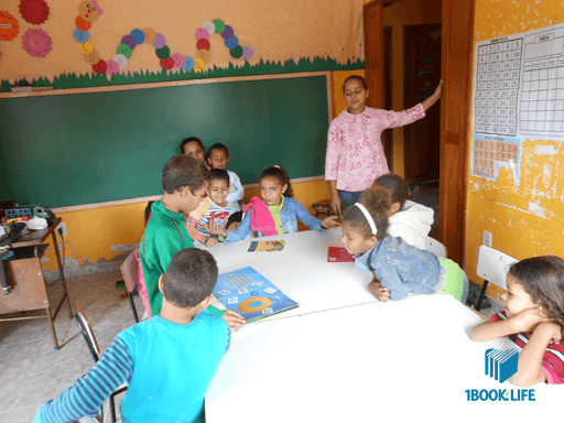 students at the school with books and teacher